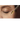 ojo cerrado de mujer con cuentagotas para aplicar tratamiento facial.